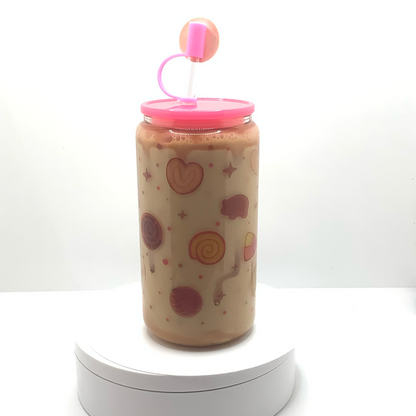 Glass can with a pink lid. Various Meican cookies sublimated on the background