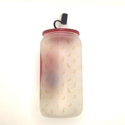 16 oz frosted glass can with sublimated image of a bear in a blue jacket singing "Choose Me" into a heart shaped microphone. Yellow musical notes are the background. Red acrylic lid  with balck heart straw cover 