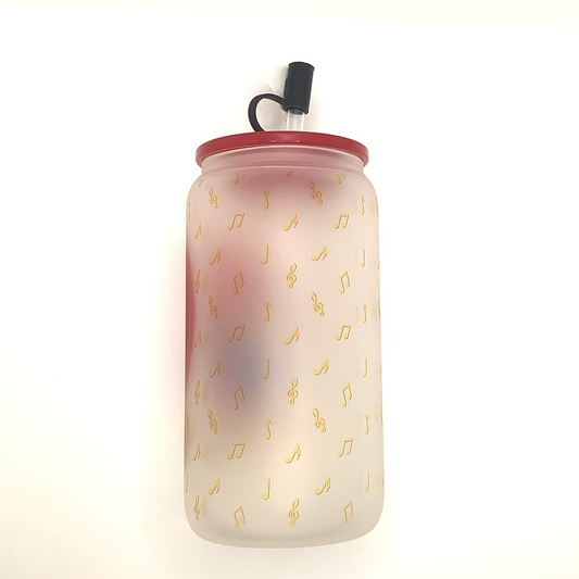 16 oz frosted glass can with sublimated image of a bear in a blue jacket singing "Choose Me" into a heart shaped microphone. Yellow musical notes are the background. Red acrylic lid  with balck heart straw cover 